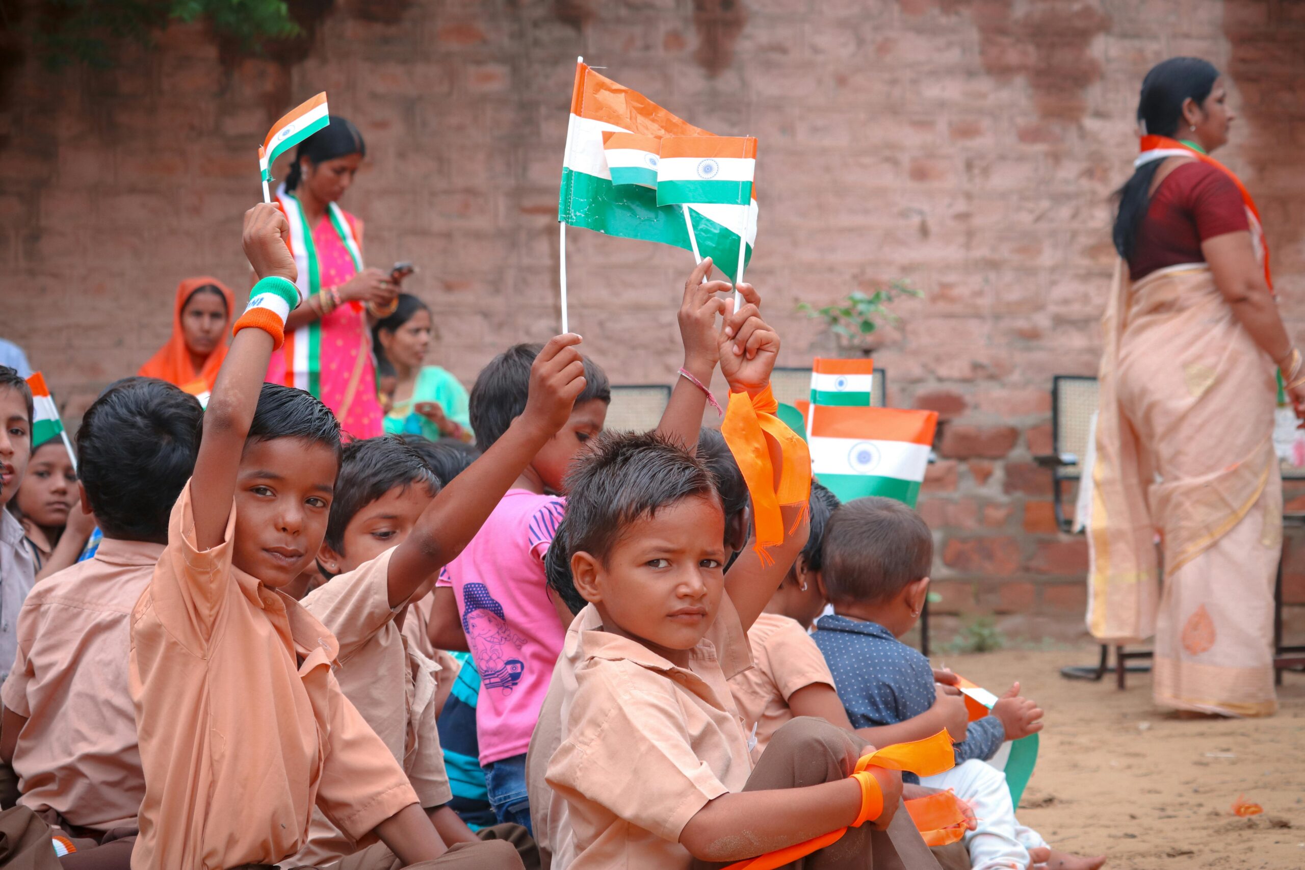 Children in Jodhpur celebrating with Indian flags. Joyous and festive atmosphere outdoors.